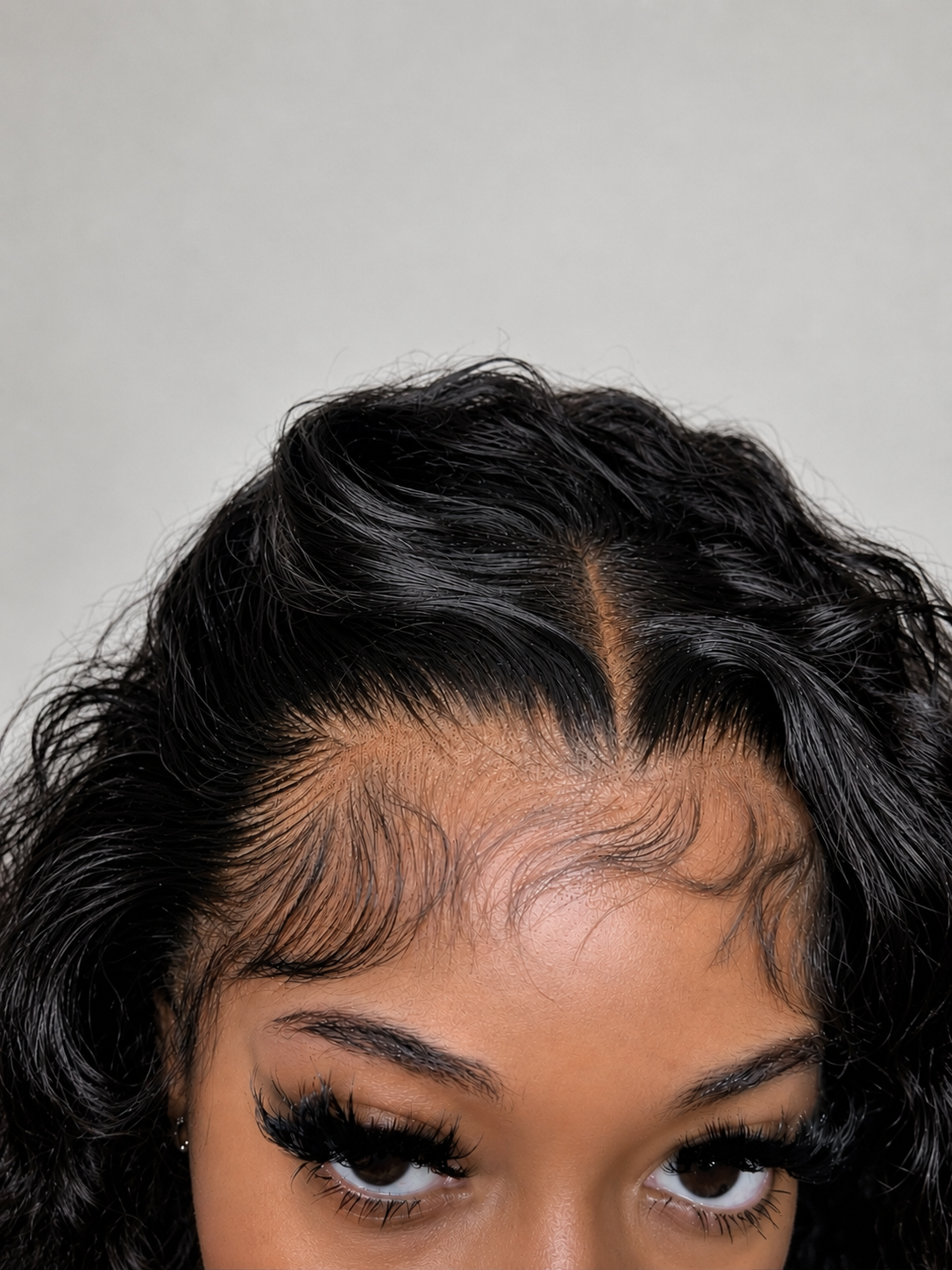 Close-up of an undetectable hand-tied lace hairline on a Black woman, showing baby hairs and natural density